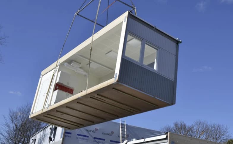 Crane lifting unit onto the site